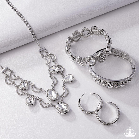 Silver ( Imitation)  jewelry set including necklace, bracelet, ring, and hoop earrings on a light gray background
